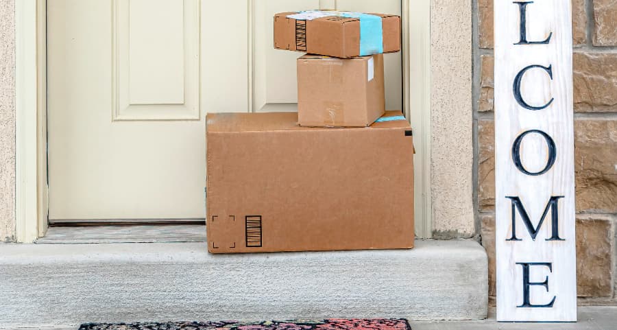 Packages on the doorstep of a home with a welcome sign in Fort Myers